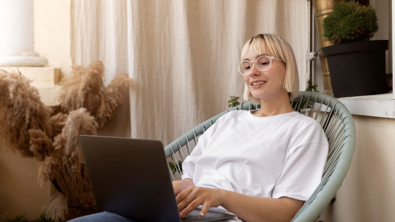 young-blonde-woman-working-from-home-her-chair