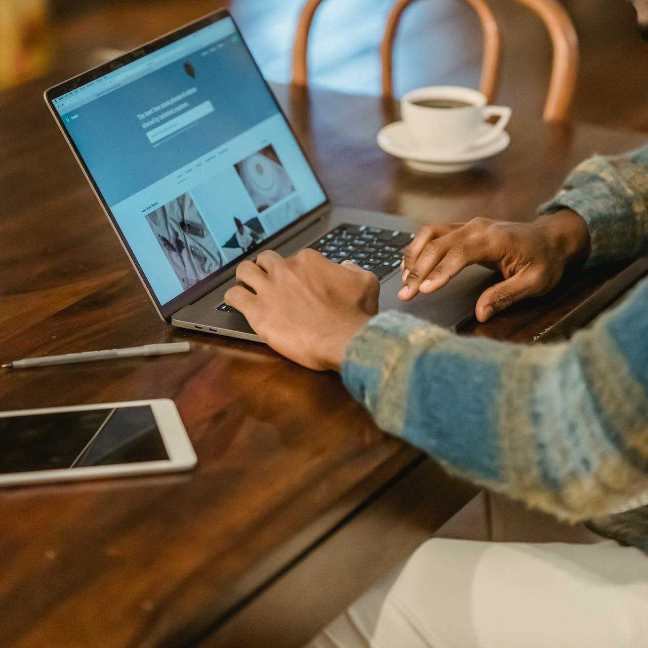 man with coffee using computer-andres-ayrton