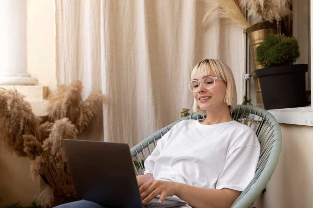 young-blonde-woman-working-from-home-her-chair1 young-blonde-woman-working-from-home-her-chair1