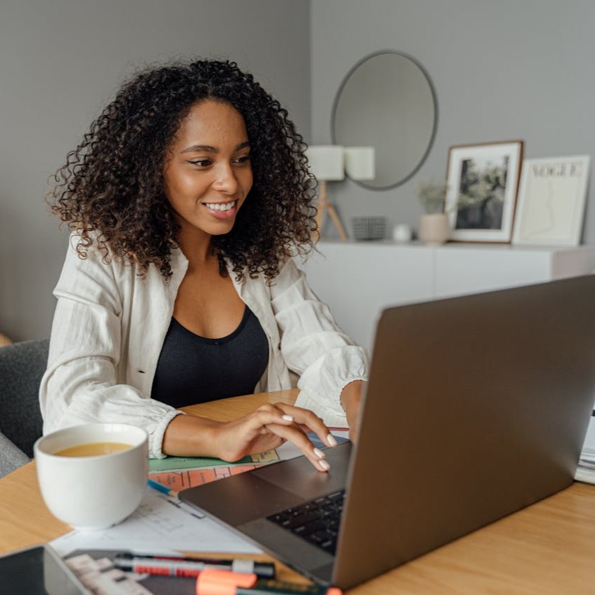 smiling girl using computer-shkrabaanthony