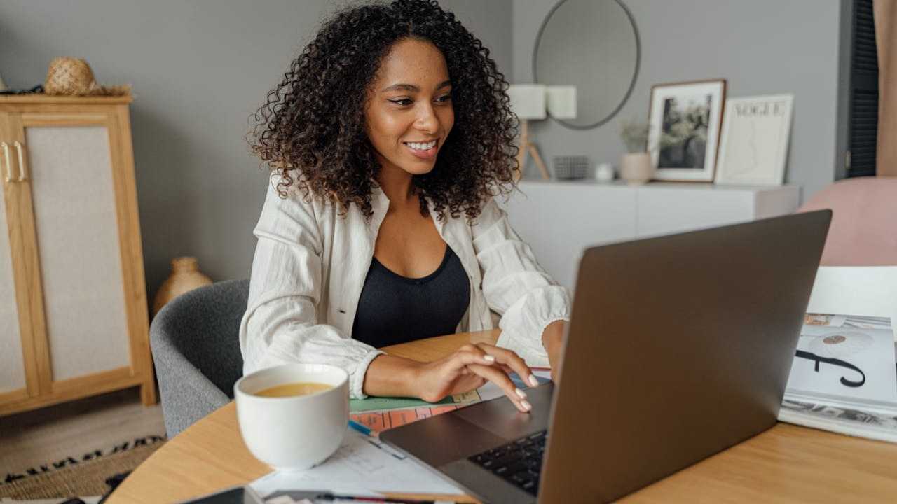 smiling girl using computer in her room-shkrabaanthony